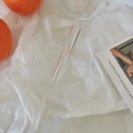Detail of eco-friendly glass straw featuring delicate yellow and purple butterfly prints - Dopamine Butterfly