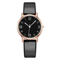 Close-up of leather strap watch with rose gold case and black Arabic numeral dial - Black