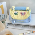Close-up of blue plaid pencil case with yellow flap and colorful butterfly embroidery - Blueberry Pudding