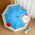 Detail of blue and white folding umbrella featuring cute red apple and yellow star patterns - Half Apple