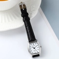 Detail of tonneau-shaped silver watch case with black leather strap on elegant background - Black Strap Silver Case White Dial