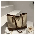 Detail of minimalist tote bag with golden bow ornament and brown leather trim accents - Khaki