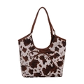 Chic cow print tote bag with bow detail and brown leather handles on white background - Brown
