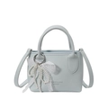 Light blue faux leather bucket bag with lace bow charm and crossbody shoulder strap - With Pendant / Blue