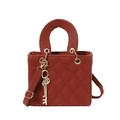 Elegant brick red quilted handbag with gold hardware and circular handles shown on white background - Red with Pendant