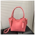 Detail of pink crossbody bucket bag with golden ring hardware and matte leather texture - Pink