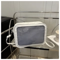 White mesh crossbody tote with adjustable strap displayed on a metal shelf - White