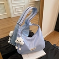 Light blue crescent shoulder bag with white cloud plush charm and wide strap detail - With Pendant / Blue