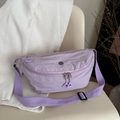 Minimalist lavender nylon crescent crossbody bag on a chair with pleated texture detail - Purple