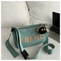 Detail of mint green oxford tote with TREND letter patch and fuzzy monster charm - With Pendant / Green