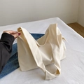 Large capacity canvas tote bag in off-white featuring a black FASHION side label - White Without Charm