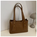 Detail of brown tote bag featuring white contrast stitching and gold metal rivets - Brown