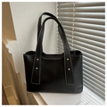 Detail of black tote bag featuring white contrast stitching and gold metal rivets - Black