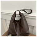 Detail of vintage textured dark brown leather tote bag showing soft material and draping - Coffee