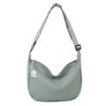 Light green crescent crossbody bag with vertical texture and cute poodle charm - Green