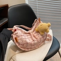 Pink and white tweed crescent bag with yellow plush charm on a casual knit top - With Pendant / Pink