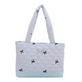 Light blue quilted tote bag with black bow embroidery and metal bow detail - Blue