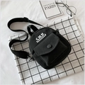 Minimalist black canvas crossbody bag with white CMN print and adjustable strap - Black