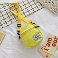 Mini yellow canvas crossbody bag with adjustable strap and multiple zip pockets - Yellow