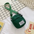 Mini dark green canvas crossbody bag with adjustable strap and front pocket detail - Green