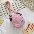 Mini light pink canvas crossbody bag with adjustable strap and front pocket detail - Pink