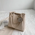 Cream-colored embossed tote bag with cartoon patterns and matching bear charm pendant - Off White