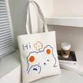 White canvas tote bag featuring a blue cartoon bear print and orange flower detail - White Style 5