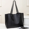 Minimalist black pebbled leather tote bag with long straps and decorative pendant charm - Black