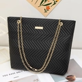 Elegant black quilted tote bag with golden chain strap and wave embroidery design - Black