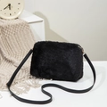 Crossbody plush handbag in black faux fur with leather strap and golden hardware accents - Black