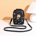 Detailed view of black embroidered mini crossbody bag with a golden metal buckle lock - Black