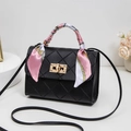 Black quilted crossbody bag with golden lock and pink floral scarf on handle - Black