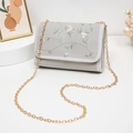 Light gray chain crossbody bag featuring detailed floral embroidery and gold metal strap - Gray