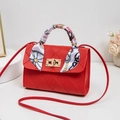 Classic red quilted crossbody bag with gold twist lock and elegant floral handle scarf - Red