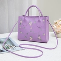 Purple embroidered tote bag with pink floral details and a crossbody strap for women - Purple