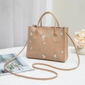 Beige floral embroidered handbag with top handles and adjustable crossbody strap - Khaki