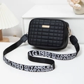 Black quilted crossbody bag with a branded wide shoulder strap and golden metal plate - Black