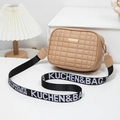 Beige quilted crossbody camera bag with gold plaque and wide lettered textile strap - Khaki