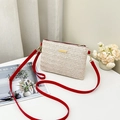 Woven straw crossbody bag with cream body and contrast red shoulder strap details - Red