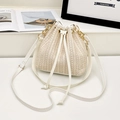 White woven bucket bag with beige straw texture, white leather drawstring, and gold chain strap - White