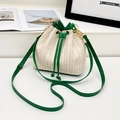 Chic beige straw bucket bag featuring vibrant green leather drawstrings and shoulder strap - Green