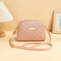 Pink quilted crossbody camera bag with gold hardware and adjustable strap in shell shape - Pink