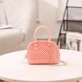 Pink jelly crossbody shell bag with beaded texture and gold chain strap on marble surface - Pink