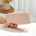 Pink quilted double-zipper wallet with plush pom-pom charm and wrist strap for women - Pink