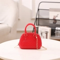 Mini red shell jelly bag with beaded texture and gold chain strap in a stylish indoor setting - Red