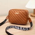 Brown quilted crossbody bag with stylish patterned wide strap and metallic logo plate - Brown