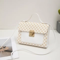 White leather square crossbody bag with gold circular patterns and metallic clasp - White