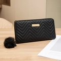 Women's long black chevron quilted wallet with gold zipper and plush ball charm - Black