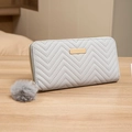 Light gray long wallet for women with V-shaped quilting and a fluffy pom-pom charm - Gray
