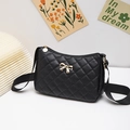 Quilted black baguette bag with gold metal bow and wide fabric shoulder strap - Black